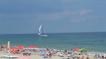 On the beach, sun-loungers, beach umbrellas, beach towels
