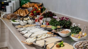 A buffet with various food items including cheeses, fruits, and vegetables. - Nofey Habashan (HaGalil HaElyon)