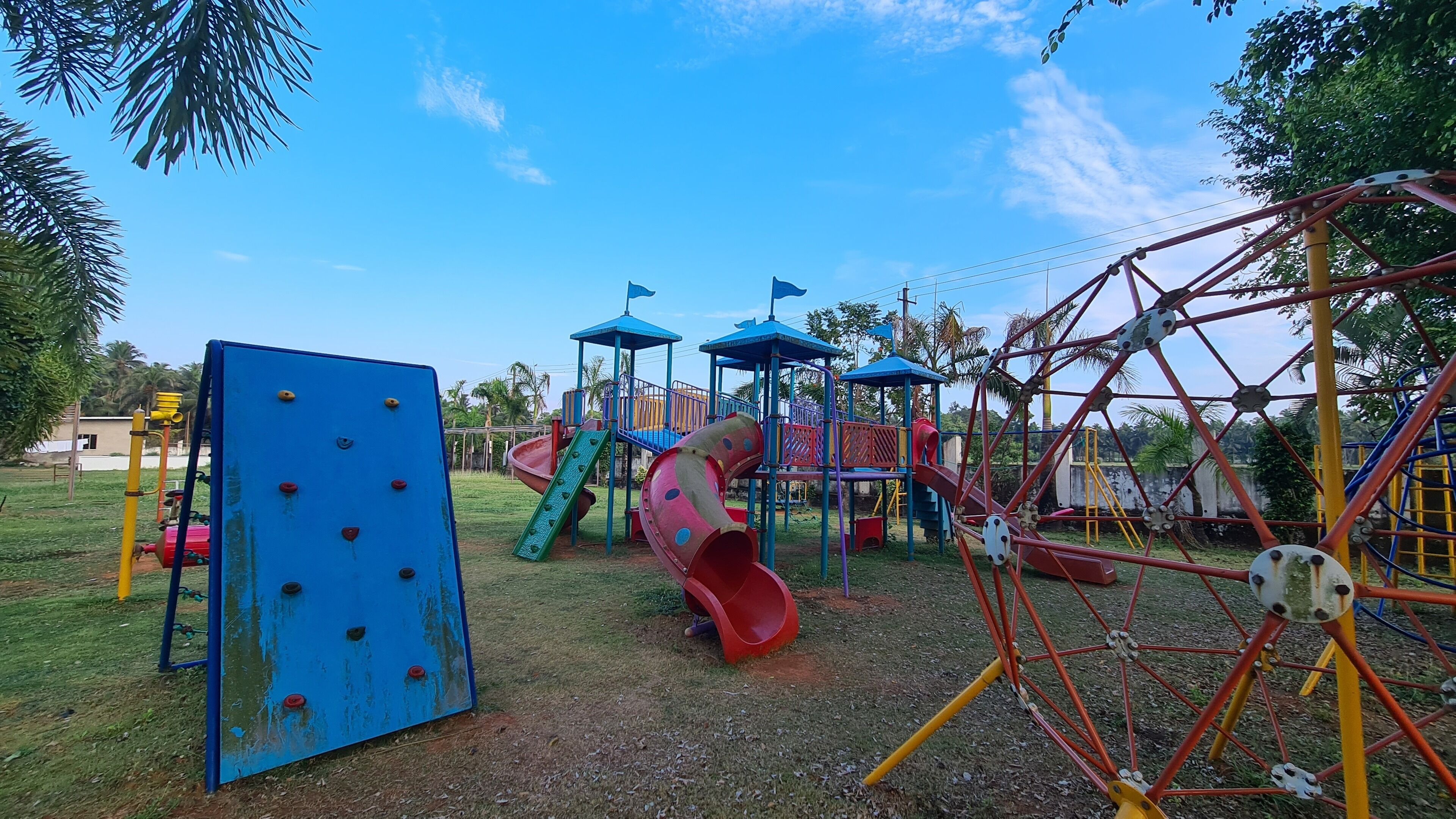 A playground with various play structures including slides and climbing areas.