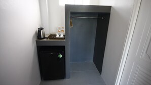 A compact bathroom with a small sink, a coffee maker, and a trash bin. - Wannachart Boutique Resort (Tha Sala)