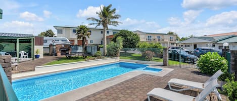 Outdoor pool, open 8 AM to 8 PM, pool loungers