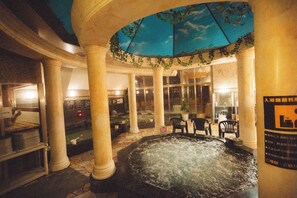 A spa area with a hot tub, seating, and a ceiling with a sky mural. - BadenGarden (Former Bed & Spa) (Tokorozawa)