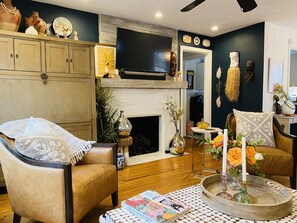 Relax in a cozy living space with a comfortable seating area, fireplace, and flat-screen TV.