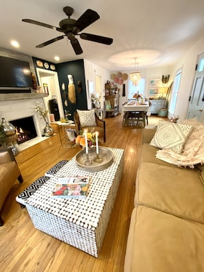 Relax in a cozy living space with a fireplace, comfortable sofa, and dining area.