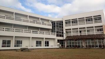 A modern building with multiple floors, large windows, and a flat roof.