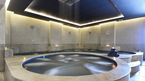 A modern spa with a large circular hot tub, stone walls, and a ceiling with integrated lighting. - Memoire Palace Resort & Spa (Siem Reap)