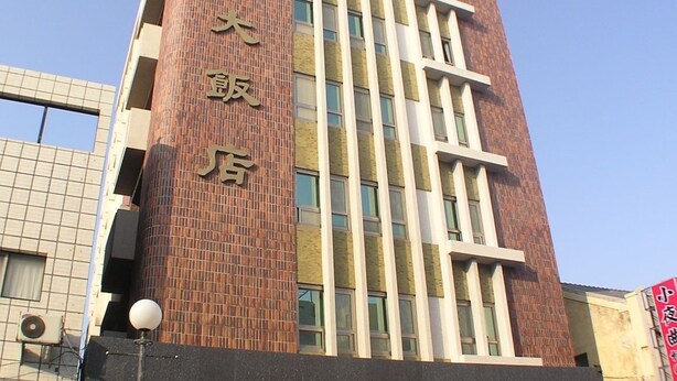 A tall hotel building with a prominent sign on the facade. - Foung Kou Hotel (Magong)