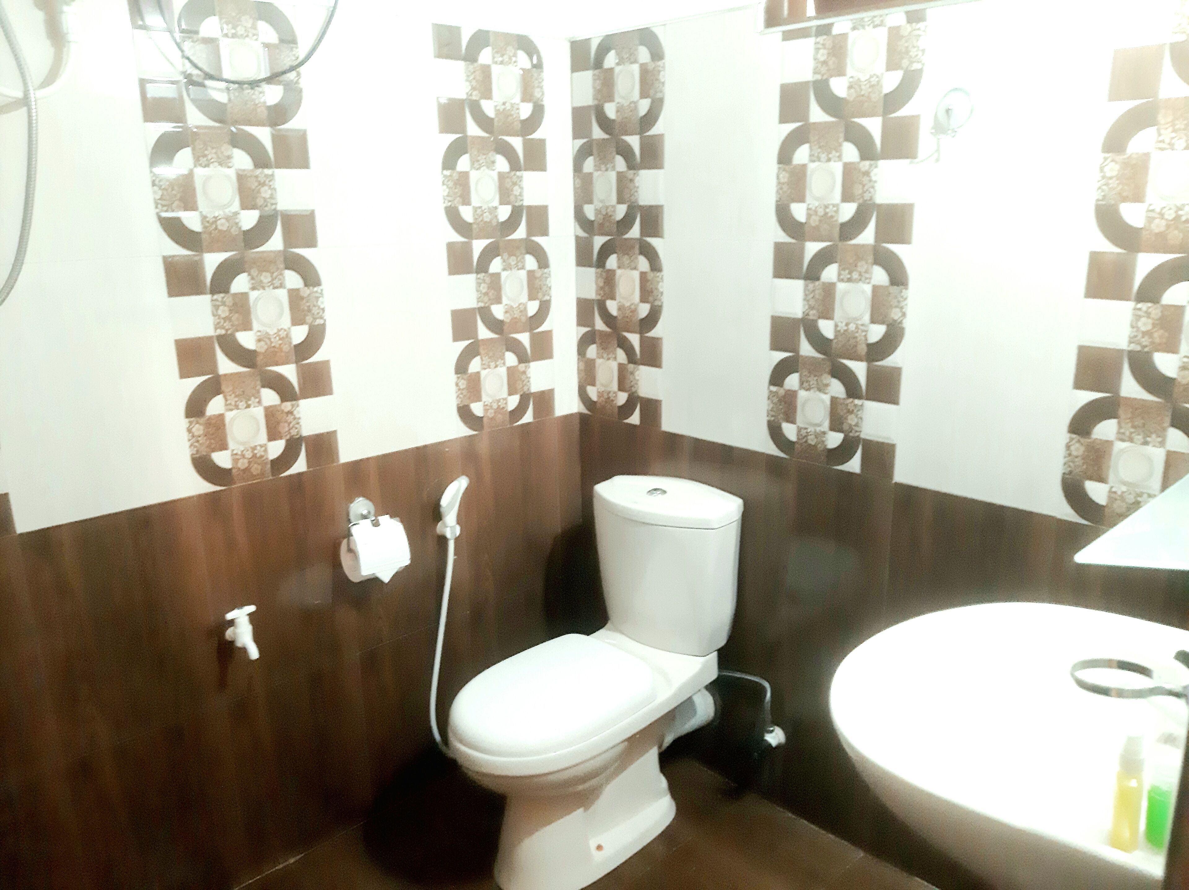 A bathroom with a toilet, sink, and shower.
