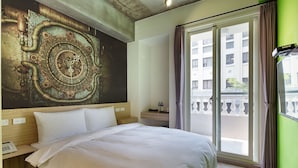 A hotel room with a large bed, a wall clock, a window with curtains, and a view of the outside balcony. - CHECK inn Express Taichung Yizhong (Taichung)