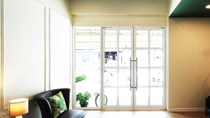 A spacious room with a large sliding glass door leading to an outdoor area. - Buakham Rim Khong (Chiang Saen)