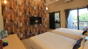 A hotel room with two beds, a wooden wall panel, a flat-screen TV, a small table with a kettle, and a balcony with a view. - I See U Inn (Xincheng)