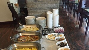 A buffet setup with various food items and utensils. - Shuian Lakeside Hotel (Yuchi)