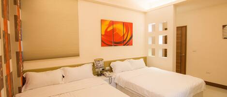 A hotel room with two beds, a painting on the wall, a telephone, and a door.