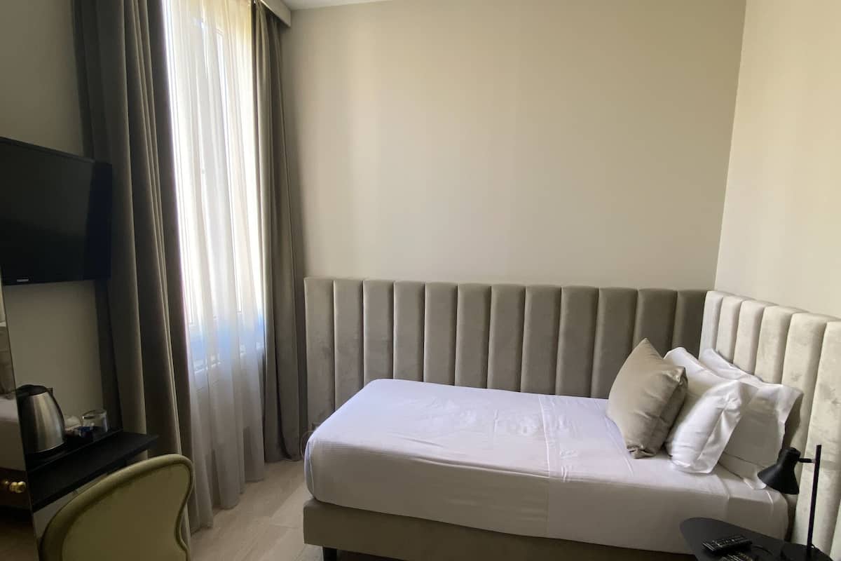 Eenpersoonskamer | Een minibar, een kluis op de kamer, een bureau, verduisterende gordijnen