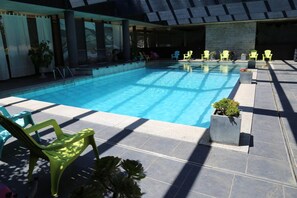 Seasonal outdoor pool, open 9:30 AM to 7:30 PM, pool loungers