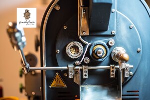 A close-up of a mechanical device with a warning sign for a hot surface.