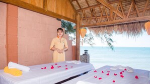 A spa room with two beds, each with a white sheet and towels, and a wooden ceiling. - Viva Beach Resort Mui Ne (Mui Ne)