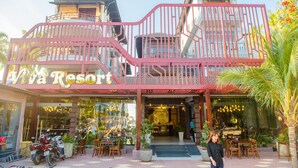 Viva Resort with a prominent pink railing, outdoor seating area, and visible restaurant interior. - Viva Beach Resort Mui Ne (Mui Ne)