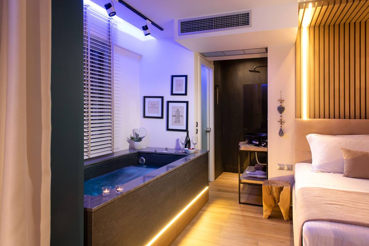 A modern bathroom with a bathtub, a vanity with a mirror, and a shower area.