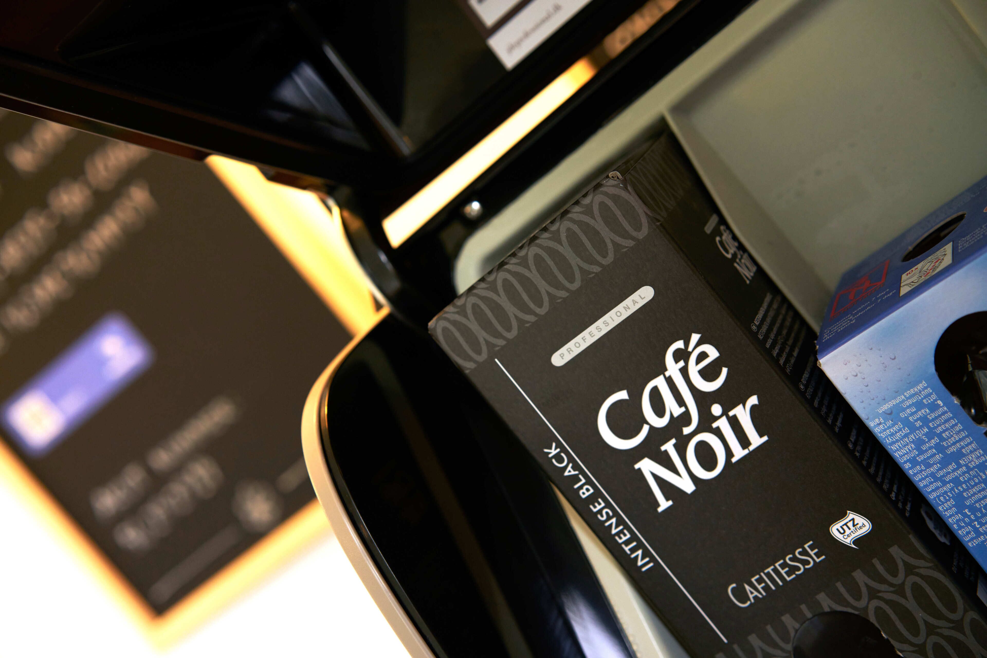 A close-up of a black and white menu with the text "Café Noir" and "Cafetesse" visible.