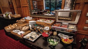 A buffet setup with various food items and condiments. - Hotel Golfi (Podebrady)