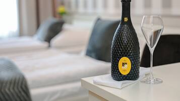 A bottle of BePIL NEO DOC EXCITING wine and a wine glass on a table in a hotel room.