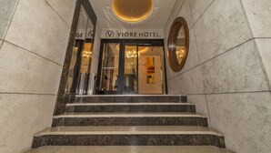 A hotel entrance with a grand staircase, a circular ceiling design, and a modern interior visible through the glass doors. - Viore Hotel (Istanbul)