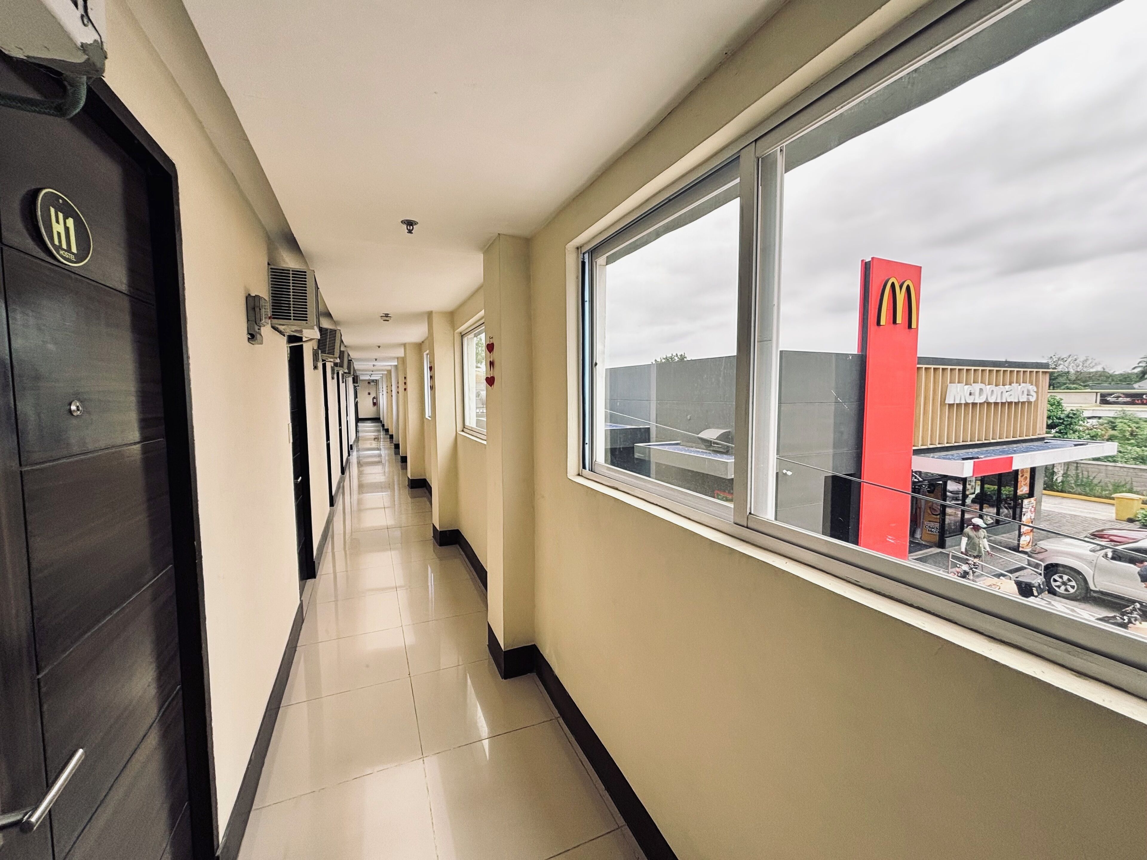 A hotel corridor with a view of a McDonald's restaurant outside.