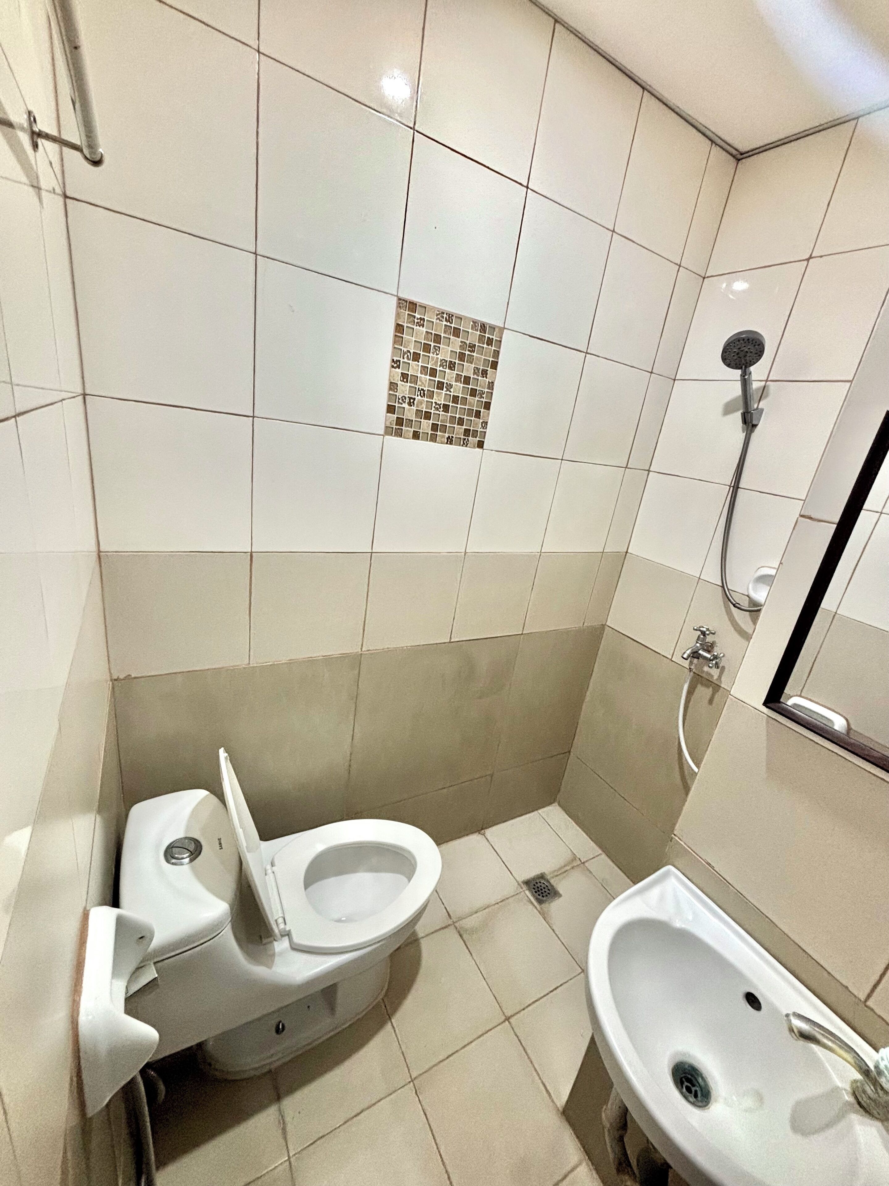 A small bathroom with a toilet, bidet, and sink.