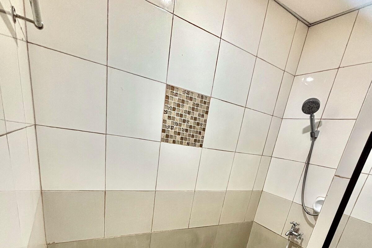 A small bathroom with a toilet, bidet, and sink.
