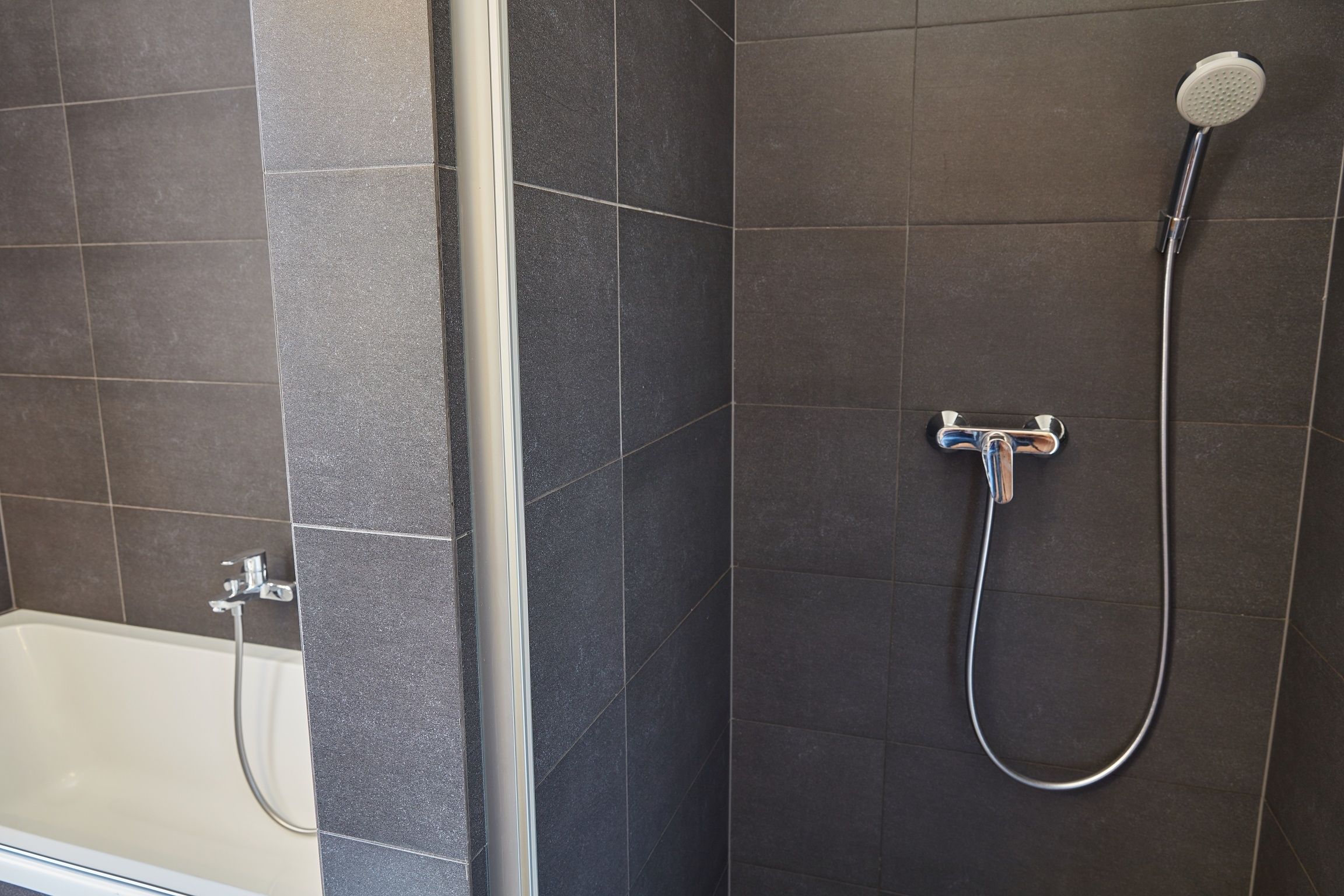 A bathroom with a bathtub and a shower.