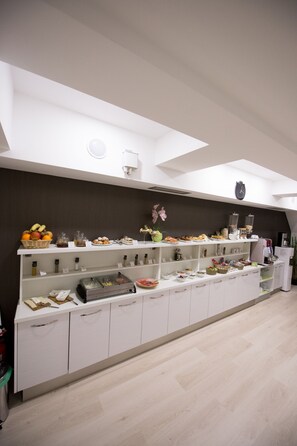 A buffet setup with various food items and condiments.