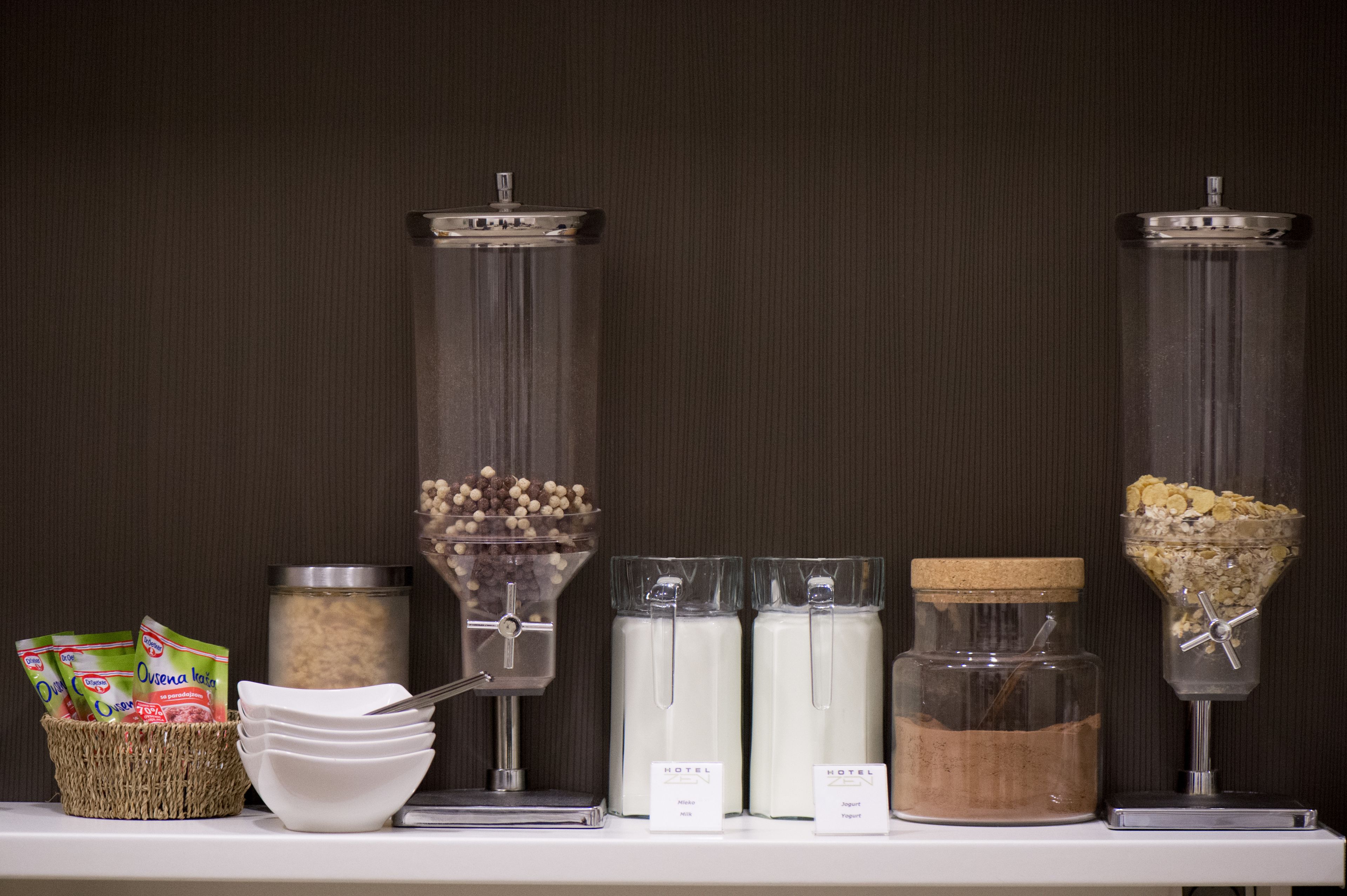 A self-serve breakfast station with various food options and containers.