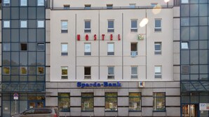 A hostel building with a sign reading "HOSTEL" and a bank named "Sparda-Bank" below it. - Babelfish Hostel (Würzburg)