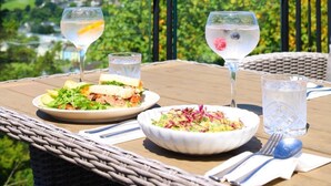A table set outdoors with a view of a green landscape. - The Eagle House Hotel (Launceston)