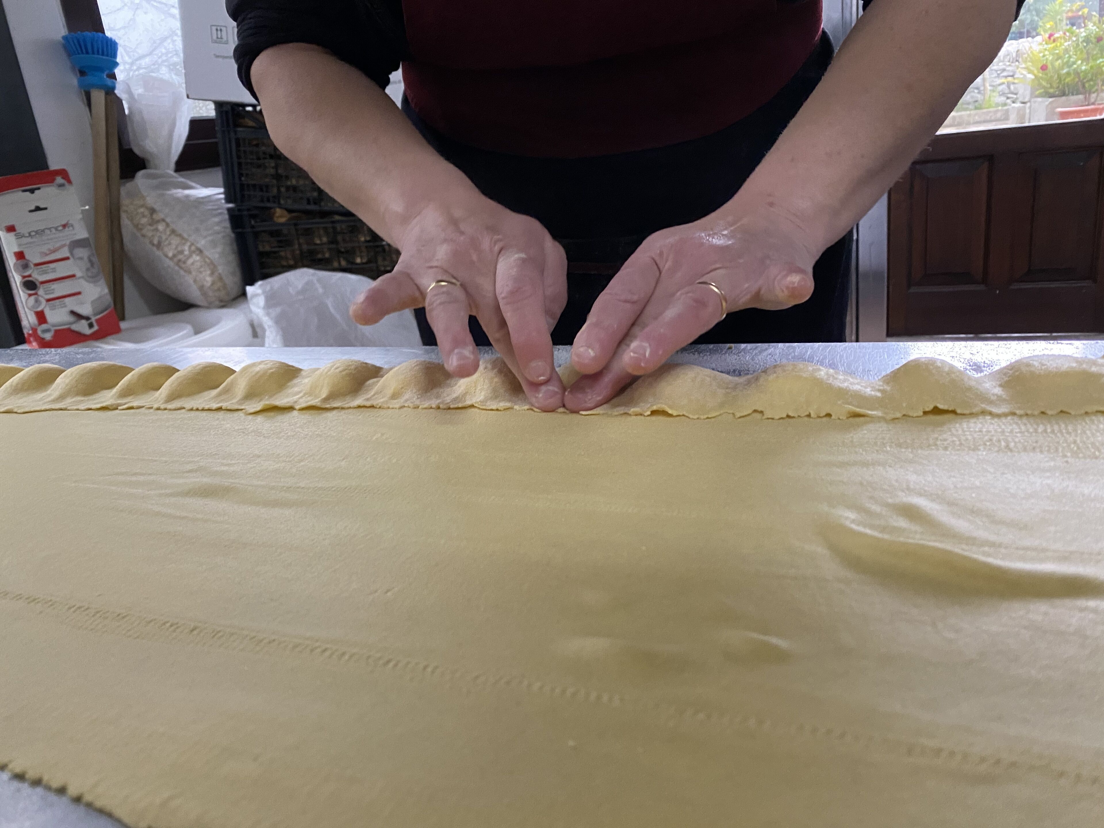 A person preparing dough on a table.