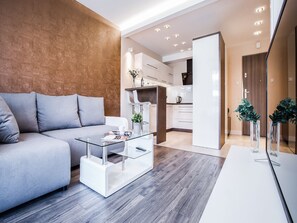 Deluxe Apartment, 1 Bedroom, Balcony | Living area | 55-inch flat-screen TV with cable channels, TV, Netflix
