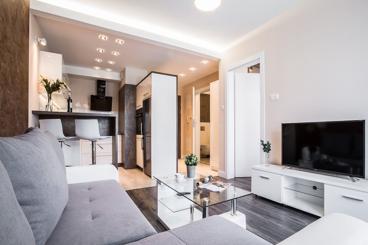 deluxe apartment, 1 bedroom, balcony | living area | 55-inch flat-screen tv with cable channels, tv, netflix