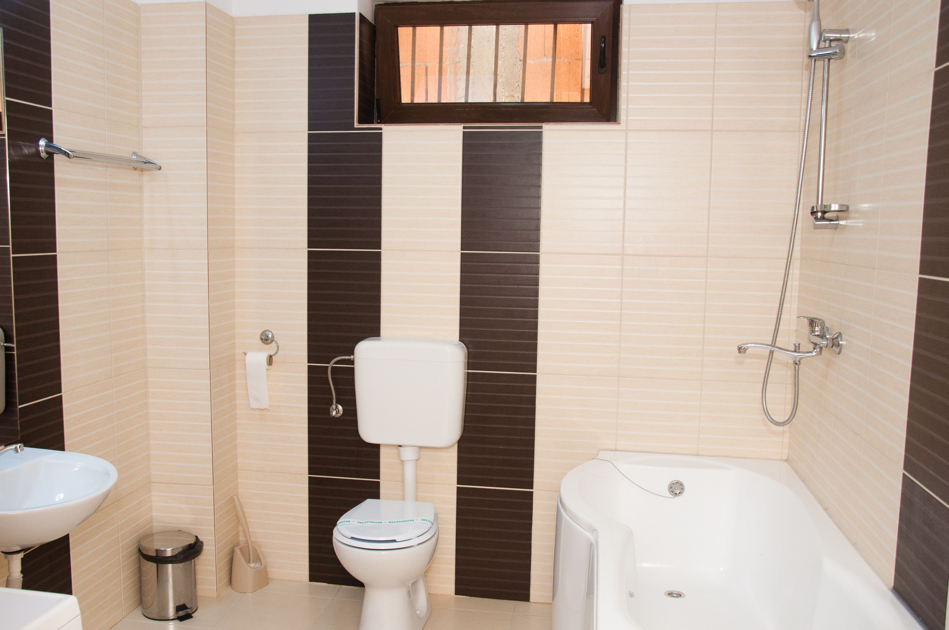 A bathroom with a toilet, sink, and bathtub.