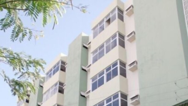 A multi-story building with a flat facade, several balconies, and a ground-level entrance. - Hotel Imperial (Mossoro)