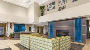 A spacious lobby with a large seating area, a reception desk, and a television. - Best Western Plus Centralia Hotel & Suites (Centralia)