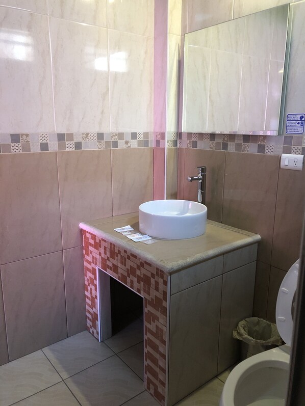 A bathroom with a white sink, a mirror, and a toilet. - Hotel & Villas 7 (Mexico City)