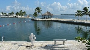A waterfront area with a dock, a gazebo, and a bench. - Dock, Htd 80' Pool, Deep Channel, 15 Min To Key West  (Cudjoe Key)