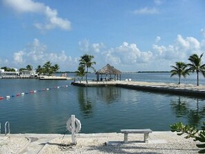 A waterfront area with a dock, a gazebo, and a bench. - Dock, Htd 80' Pool, Deep Channel, 15 Min To Key West  (Cudjoe Key)