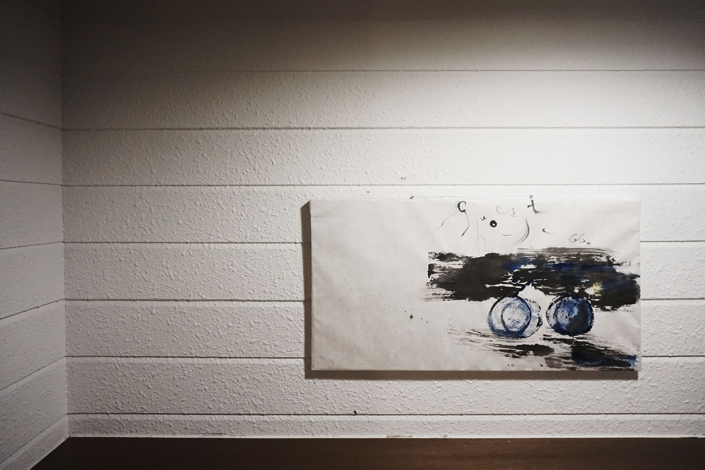 A painting on a white textured wall.