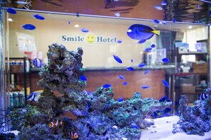 An aquarium with various fish and coral formations.