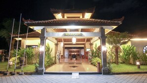 A reception area with a traditional architectural style, featuring a tiled roof and a sign that reads "RECEPTION".