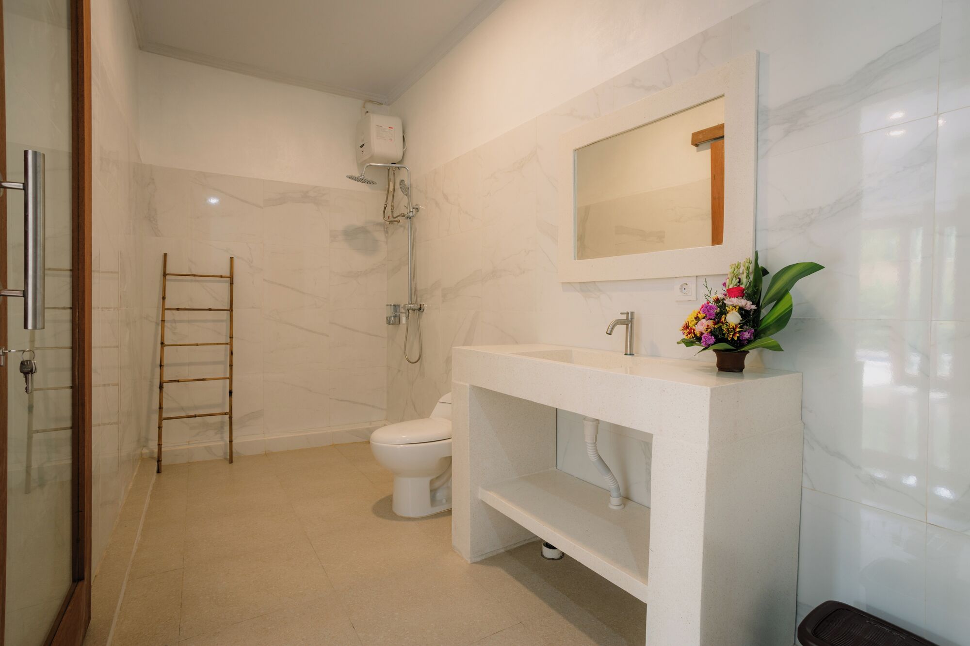 A modern bathroom with a toilet, shower, and sink.