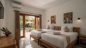 A modern bedroom with two beds, a wooden headboard, a small table, and a TV. - Mag Canggu Bali (Canggu)