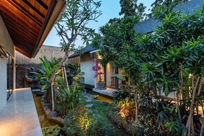 Escape to a serene oasis with lush tropical plants and a soothing water feature.